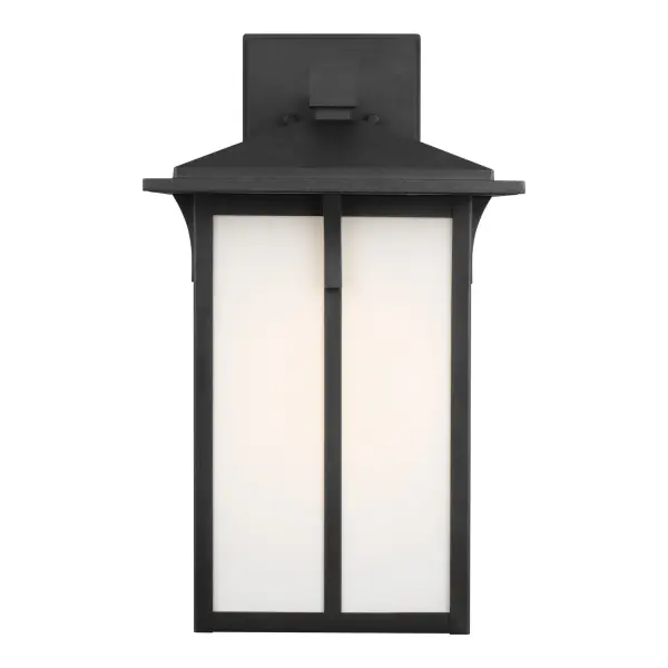 The Tomek wall lantern combines timeless lantern styling with contemporary aluminum construction. Its etched white glass diffuses light beautifully while the wet-rated design ensures reliable performance in all weather conditions.