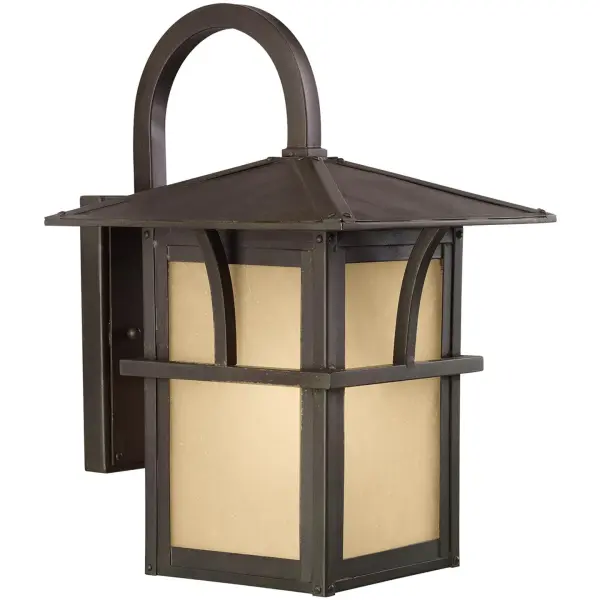 The Medford Lakes wall lantern combines traditional styling with coastal charm. Its statuary bronze finish and etched hammered glass create a warm, inviting ambiance perfect for outdoor entryways and porches.