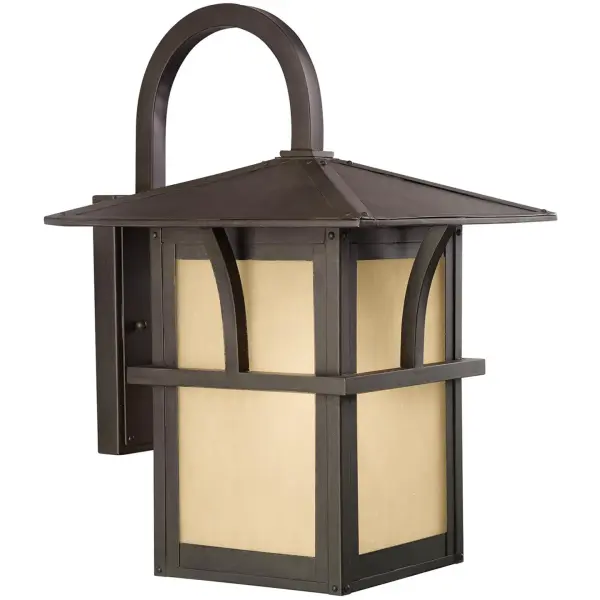 The Medford Lakes wall lantern combines traditional styling with durable aluminum construction and wet-rated performance. Its etched hammered glass with light amber tint creates a warm, inviting glow perfect for coastal and traditional homes.