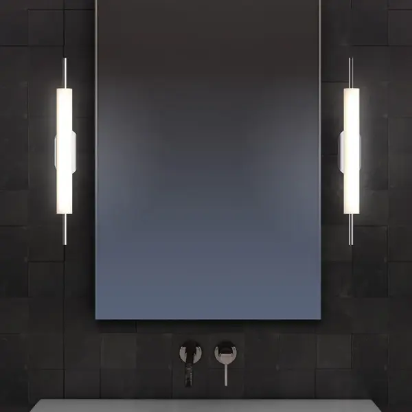 The Piccolo Encore LED Sconce reimagines dramatic simplicity with a refined flute-like cylindrical form. Featuring a powerful integrated LED engine with 940 delivered lumens and excellent 90 CRI, this polished chrome fixture delivers both style and performance in a compact 24-inch profile.