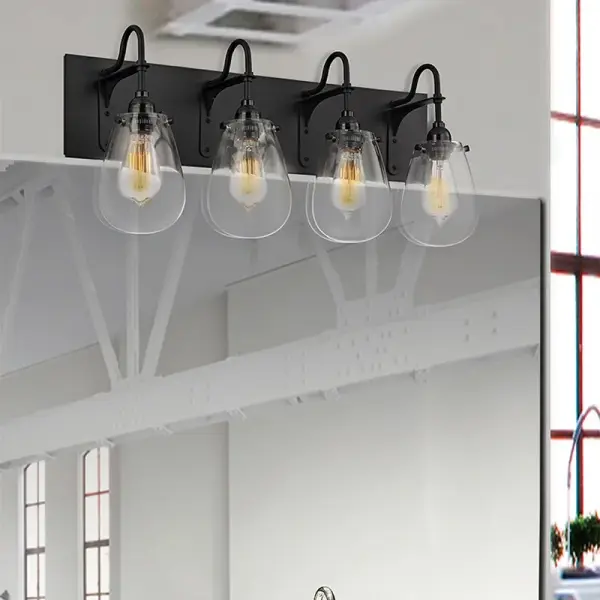 The Chelsea Bath Bar combines historic carbon filament styling with contemporary industrial design. Its voluptuous glass globes and black metal cord create a striking focal point perfect for modern bathrooms and vanity areas.