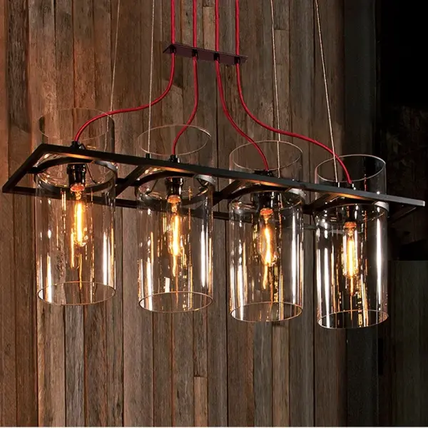 This compact 2-light pendant blends industrial metal framework with elegant clear glass cylinders in a striking geometric composition. The square-meets-circle design creates visual interest while the satin black finish adds contemporary edge.