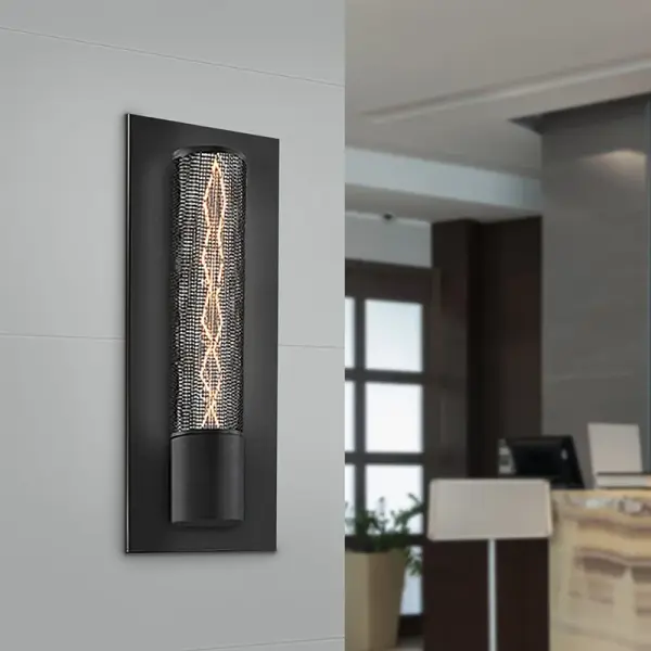The Urban Edge Panel Sconce delivers downtown loft style with its distinctive black wire mesh panel that beautifully showcases a helix filament bulb. At just 5" wide, it's perfect for tight spaces while making a bold design statement.