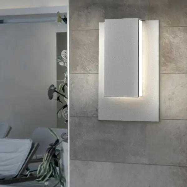 The Reveal Short LED Sconce combines contemporary design with integrated LED technology in a polished nickel finish. Its compact profile makes it ideal for bathrooms, hallways, and smaller spaces requiring efficient task lighting.
