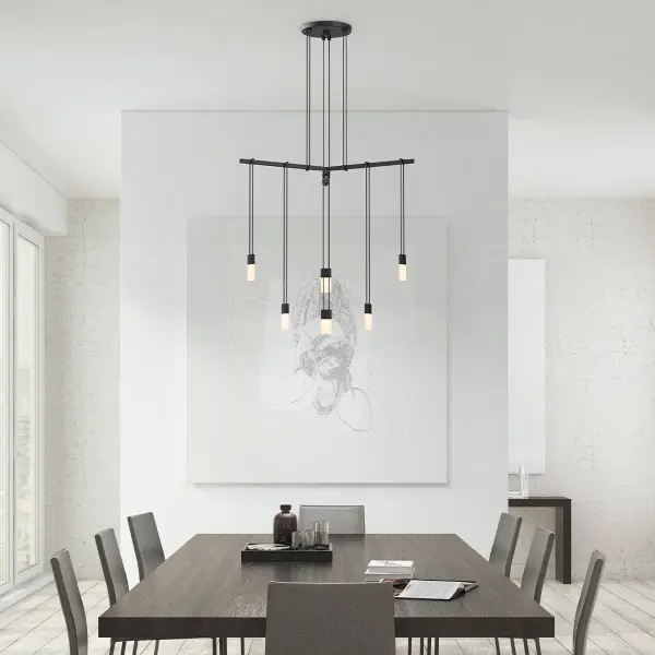The Suspenders 24" pendant features a unique 120-degree tri-bar configuration with etched chiclet luminaires suspended at staggered heights, creating a luminous array of minimalist simplicity perfect for modern interiors.