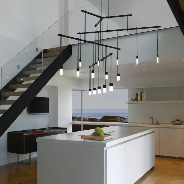 This sophisticated 4-tier tri-bar system features three linear power bars suspended at staggered heights, creating an intersecting sculptural space frame. The etched chiclet luminaires on 12" hangers reinforce the geometric linearity while providing warm, high-CRI illumination perfect for large dining and living spaces.