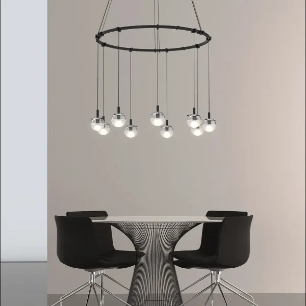 The Suspenders pendant combines architectural form with practical flexibility. Its 24-inch ring suspends etched glass spheres on adjustable cords that can be looped for custom heights, creating a dynamic focal point with warm LED illumination.