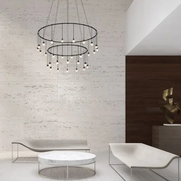 This sophisticated double-ring pendant system combines architectural scale with delicate crystal luminaires. The concentric suspended design creates dramatic depth and visual interest, perfect for grand spaces requiring statement lighting.
