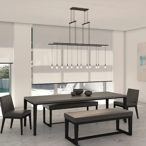 The Suspenders 48" Tandem Pendant features two tiers of etched glass cylinders suspended from a single cord, creating a refined linear statement. The omnidirectional LED light source within thin glass forms delivers both functional illumination and sculptural beauty.