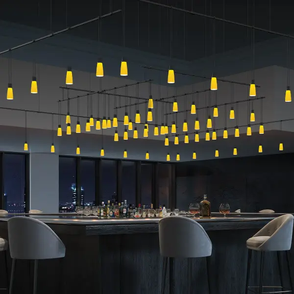 A stunning modular lighting system featuring trumpet-shaped amber glass bells arranged in concentric square patterns. The minimal structural profile and repetitive geometric design create dramatic visual impact in large spaces.