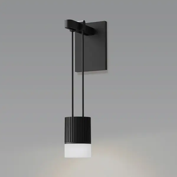 The Suspenders Mini Sconce combines functional task lighting with decorative appeal in a compact form. Its suspended cylinder design with glass drum diffuser provides both focused and soft indirect illumination, perfect for smaller spaces.