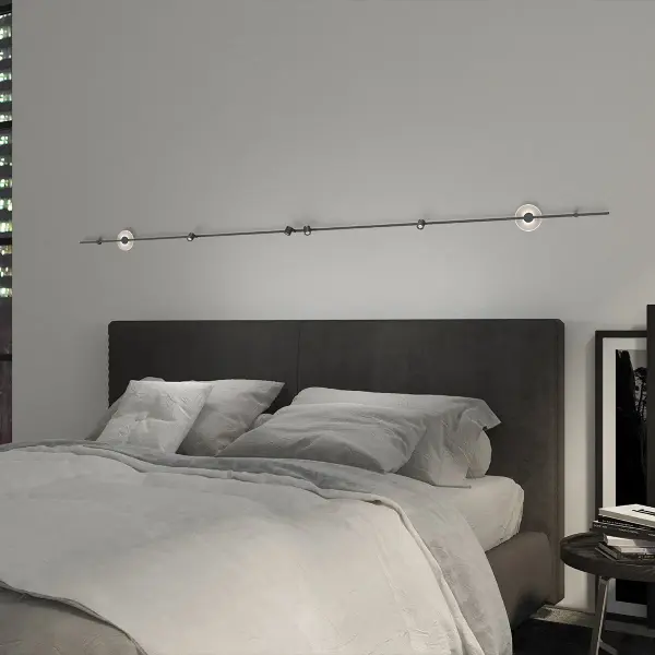 This 72-inch linear wall-mounted system combines ambient Mezzaluna luminaires with adjustable task cylinders, perfect for bedside applications requiring both general and reading light in one elegant fixture.