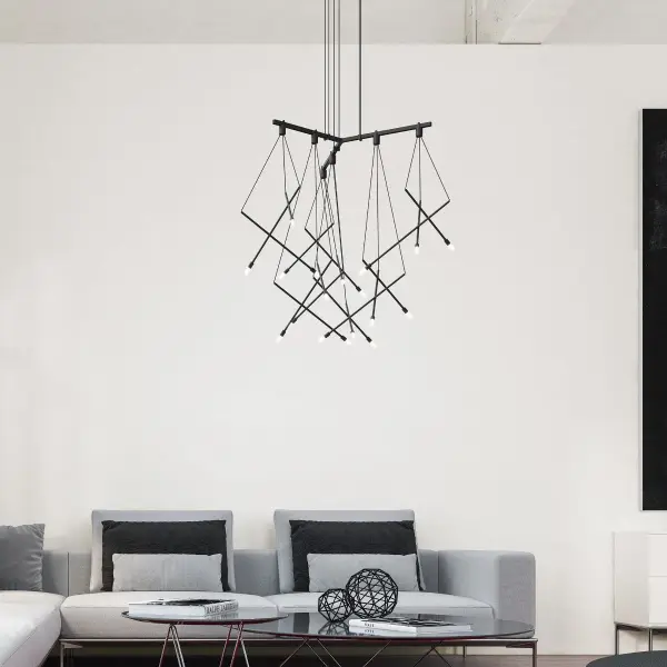 The Suspenders chandelier features six delicate branch luminaires arranged in a tri-bar configuration, creating an organic, nature-inspired statement piece. Its 32" diameter and adjustable height make it perfect for large dining spaces and grand entryways.