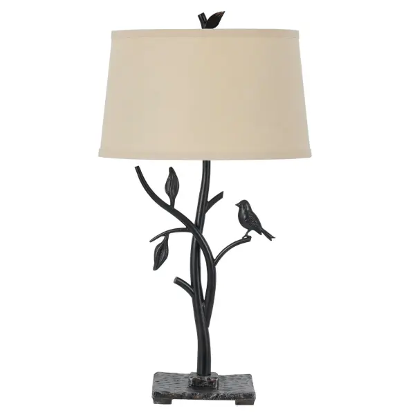The Medora table lamp showcases handcrafted forged iron artistry with an intricate tree and bird motif. Its hammered base and durable construction deliver rustic elegance with a 3-way switch for versatile lighting control.