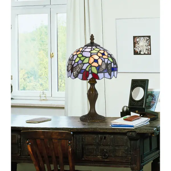 This handcrafted accent lamp features 196 pieces of authentic Tiffany stained glass paired with a durable zinc cast base in antique brass. At 14" tall, it delivers artisanal charm and warm ambient light perfect for intimate spaces. - alternate view