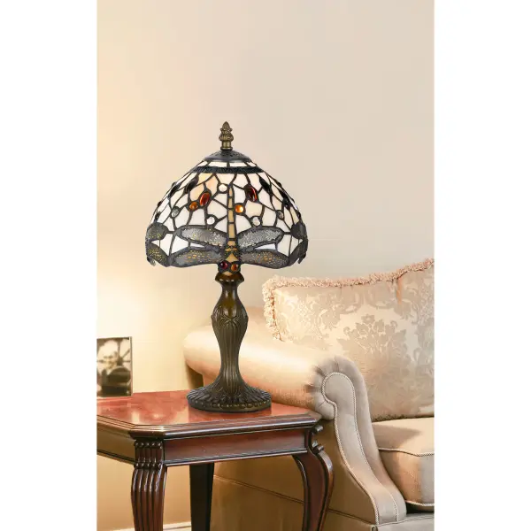 This compact accent lamp features authentic Tiffany-style stained glass with 188 individual pieces, creating beautiful ambient lighting. The durable zinc cast base in antique brass finish provides stability and classic appeal. - alternate view