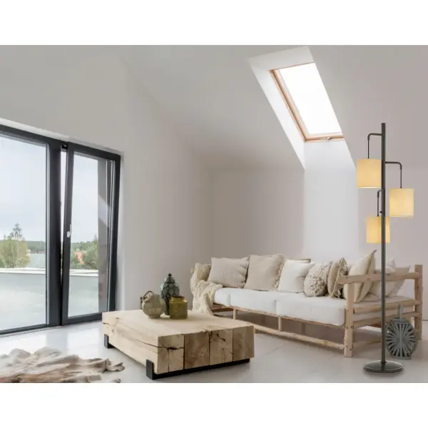 The Kirkwall floor lamp combines industrial-inspired metal lantern design with soft linen shades, creating warm ambient lighting. At 72 inches tall with three 60W bulbs, it provides substantial illumination while maintaining a refined aesthetic. - alternate view