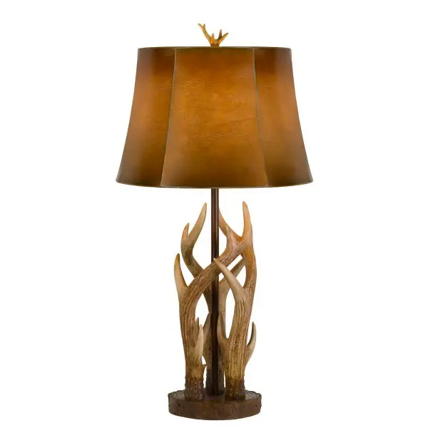 The Darby Antler Table Lamp combines rustic charm with functional lighting. Its durable resin construction mimics natural antlers in a brown/bone finish, topped with an ombre leatherette shade. At 32.5" tall, it makes a bold statement.