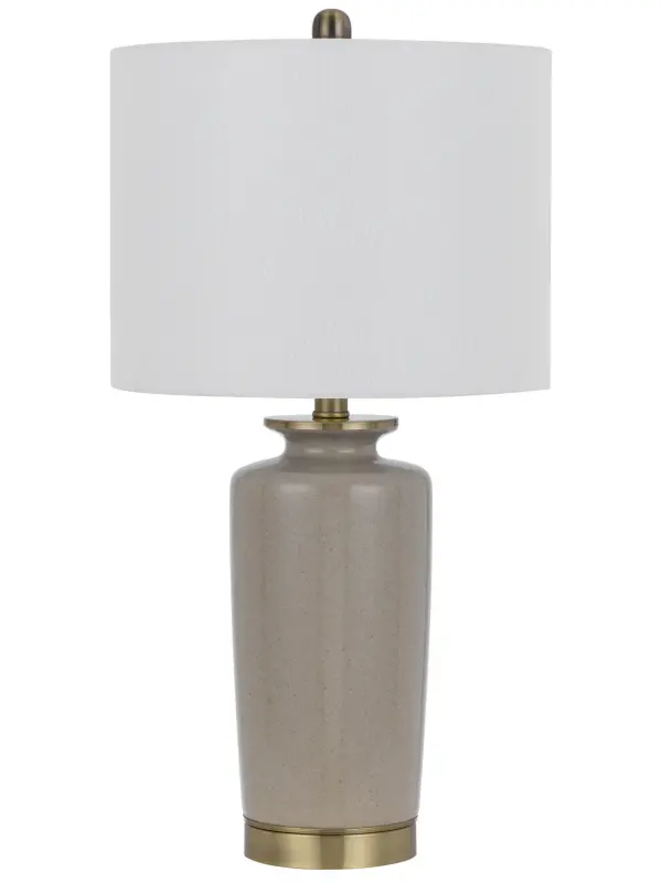 The Modica table lamp combines antique brass metalwork with a sand-toned fabric shade for sophisticated warmth. At 25.5" tall, it provides excellent task and ambient lighting while adding refined style to bedrooms, living spaces, and offices.