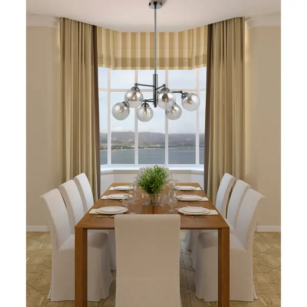 The Prato chandelier combines industrial style with contemporary elegance through six smoked glass orb pendants in a gun metal finish. Its 32-inch width makes it perfect for large dining tables and kitchen islands. - alternate view