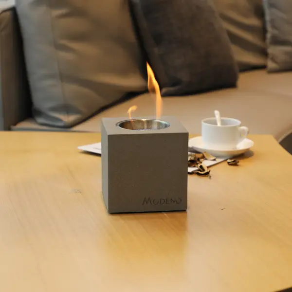 The MODENO VITO brings real flame ambiance to any tabletop with its cast concrete construction and clean-burning ethanol fuel. Compact 5-inch cube design offers 60 minutes of adjustable flame height for intimate settings. - alternate view