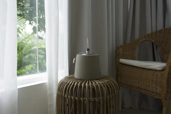 This contemporary tabletop oil lamp combines industrial concrete aesthetics with functional ambient lighting. The conical design features a cement base and stainless steel burner, providing 60 minutes of real flame warmth. - alternate view