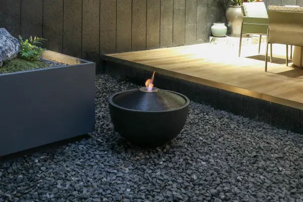 The Elementi Water Fuji combines fire and water elements in a striking 26.8-inch square bowl crafted from durable GRC concrete. This contemporary outdoor feature creates a mesmerizing focal point for patios and commercial spaces. - alternate view