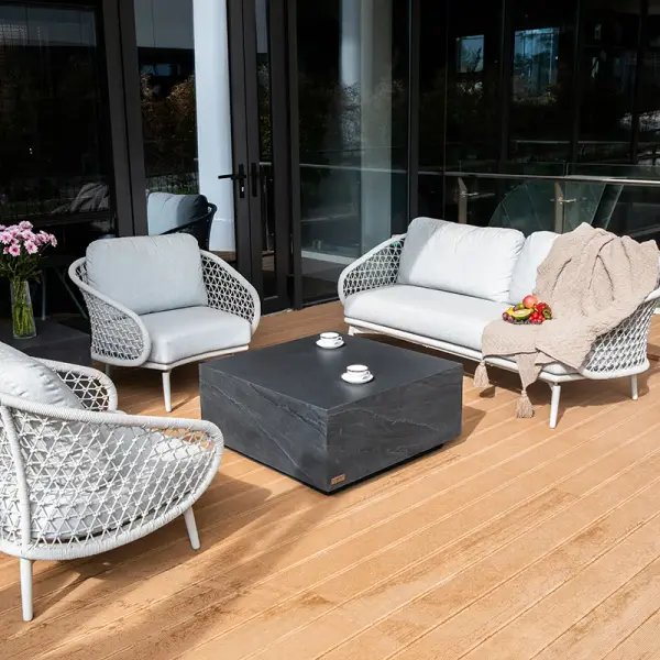 The Colorado Sandstone coffee table combines modern design with durable GFRC construction. Its 33.9-inch square top and 16-inch height provide ample surface area while the sandstone finish adds organic texture to contemporary spaces. - alternate view