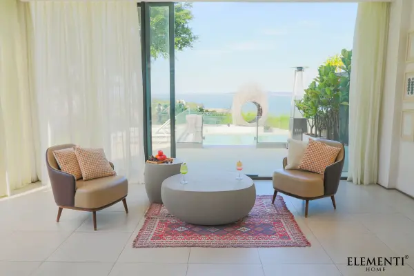 The IKARIA Cobble Coffee Table brings architectural presence with its GFRC construction and generous 42-inch square footprint. Its durable concrete composition makes it equally suited for indoor living spaces or covered outdoor areas. - alternate view