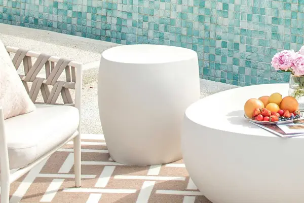 The IKARIA Cobble Side Table combines modern concrete design with organic texture. Crafted from durable GFRC (Glass Fiber Reinforced Concrete), this 19-inch square table offers versatile indoor-outdoor functionality. - alternate view