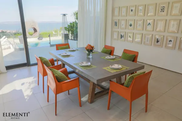 The SEINE dining table combines industrial GFRC concrete with warm solid wood feet, creating a stunning 94.5-inch centerpiece. Its substantial presence and contemporary design make it ideal for large dining rooms and commercial spaces. - alternate view
