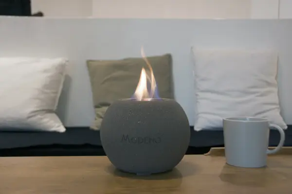 The Paffu brings real flame ambiance to any tabletop with its cast concrete construction and stainless steel burner. Compact 6.6" footprint fits easily on coffee tables or outdoor dining surfaces, providing 60 minutes of mesmerizing flame. - alternate view