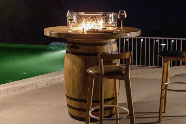 The Lafite Barrel Fire Table transforms outdoor spaces with its handcrafted concrete construction and powerful 45,000 BTU burner. At 48" square, it serves as both a functional dining surface and dramatic fire feature. - alternate view