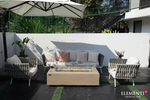The ELEMENTI PLUS Colorado Fire Table combines handcrafted glass-fiber reinforced concrete construction with a powerful 60,000 BTU stainless steel burner. Features push-button ignition and includes bronze fire glass, aluminum lid, and canvas cover. - alternate view