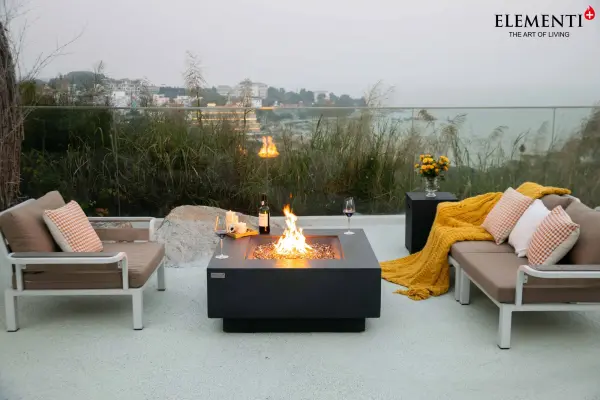 The Bergen Fire Table combines handcrafted glass-fiber reinforced concrete construction with a powerful 60,000 BTU burner system. This 40-inch square fire table features premium stainless steel components and includes bronze fire glass, aluminum lid, and canvas cover. - alternate view