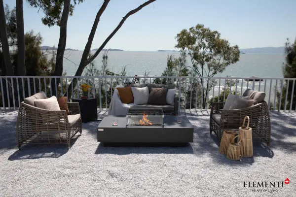 The Elementi Plus Cannes Fire Table combines handcrafted glass-fiber reinforced concrete construction with a powerful 60,000 BTU burner system. Features push-button ignition, stainless steel components, and includes bronze fire glass, canvas cover, and aluminum lid. - alternate view