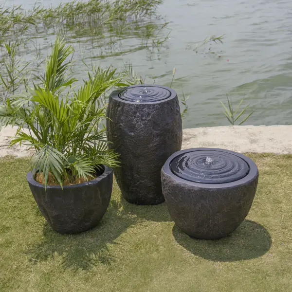 The ELEMENTI Boulder Fountain-S brings natural stone aesthetics to outdoor spaces with its dark grey glossy finish. Compact at 21.5" square, this water feature adds tranquil ambiance to patios and gardens. - alternate view