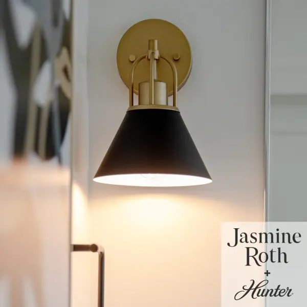 Infused with simplicity and elegance and designed in collaboration with Jasmine Roth, the Carrington Isle Sconce illuminates any space with a refined class and style. Showcasing exquisite arched details, a striking two-tone finish, and sleek, cone-shaped metal shades, the streamlined silhouette of the Carrington Isle, radiates a subtle yet sophisticated elegance. The Carrington Isle Collection effortlessly transforms any room into a luxurious haven, enchanting your guests with its resplendent shades and distinctive geometric accents. Rated for indoor spaces exposed to humidity Requires 1 E26 Bulbs. Bulbs not included. Down Mount Only TRANSITIONAL: Light, relaxed, elegant. INDOOR-DAMP RATED: For use in indoor spaces exposed to humidity like bathrooms and laundry rooms. BULB RECOMMENDATION: Maximum 60 W per light bulb or equivalent LED bulb. Bulbs not included. PICTURED HERE: Match our image using A19 Edison light bulbs. Bulbs not included. TRANSITIONAL: The transitional style celebrates natural light and a relaxed feel with smooth, blending details that create warm yet modern spaces with the best of both worlds; elegant, minimal and adaptable. WARRANTY: One-year limited warranty backed by the trusted experts at Hunter.