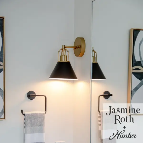 Infused with simplicity and elegance and designed in collaboration with Jasmine Roth, the Carrington Isle Sconce illuminates any space with a refined class and style. Showcasing exquisite arched details, a striking two-tone finish, and sleek, cone-shaped metal shades, the streamlined silhouette of the Carrington Isle, radiates a subtle yet sophisticated elegance. The Carrington Isle Collection effortlessly transforms any room into a luxurious haven, enchanting your guests with its resplendent shades and distinctive geometric accents. Rated for indoor spaces exposed to humidity Requires 1 E26 Bulbs. Bulbs not included. Down Mount Only TRANSITIONAL: Light, relaxed, elegant. INDOOR-DAMP RATED: For use in indoor spaces exposed to humidity like bathrooms and laundry rooms. BULB RECOMMENDATION: Maximum 60 W per light bulb or equivalent LED bulb. Bulbs not included. PICTURED HERE: Match our image using A19 Edison light bulbs. Bulbs not included. TRANSITIONAL: The transitional style celebrates natural light and a relaxed feel with smooth, blending details that create warm yet modern spaces with the best of both worlds; elegant, minimal and adaptable. WARRANTY: One-year limited warranty backed by the trusted experts at Hunter. - alternate view