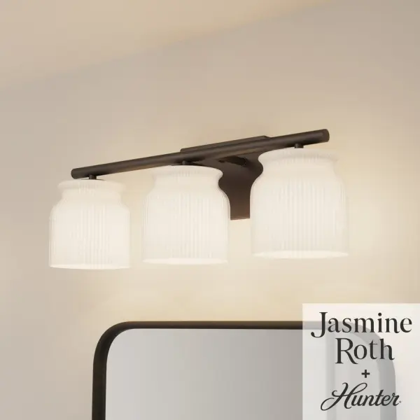 The Harlowe vanity light combines contemporary elegance with practical functionality. Its ribbed milk glass provides even, flattering illumination while the matte bronze finish adds warmth and sophistication to any bathroom. - alternate view