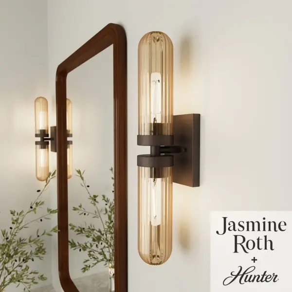 The Beverly Glen vanity light combines formal elegance with modern versatility. Its ribbed amber glass creates a warm, inviting glow while the matte bronze finish adds sophisticated contrast. Flexible mounting options make it adaptable to various bathroom layouts.