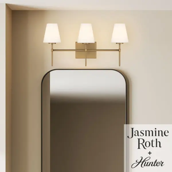 Create a warm, welcoming glow with the Camelia Stem Jasmine Roth 3 Light Vanity. Designed for bathrooms and other humidity-prone spaces, this indoor-damp rated fixture blends effortless style with a comfortable, laid-back feel. Its versatile design mounts up or down to suit your space, while three E12 bulbs, sold separately, provide customizable illumination. Thoughtfully crafted to coordinate with the Jasmine Roth lighting collection, this vanity light brings casual elegance and dependable performance, backed by Hunter's one-year limited warranty. Rated for indoor spaces exposed to humidity. Mounts Up only Comfortable, inviting, laid-back. Requires 3 E12 bulbs required (not included). INDOOR-DAMP RATED: For use in indoor spaces exposed to humidity like bathrooms and laundry rooms. CASUAL: The effortless style of Casual design creates a comfortable, inviting, and laid-back atmosphere. ANGLED CEILINGS: This fixture can be mounted on both angled and flat ceilings. COORDINATING COLLECTION: Works with Jasmine Roth Lighting collection. WARRANTY: One-year limited warranty backed by the trusted experts at Hunter.