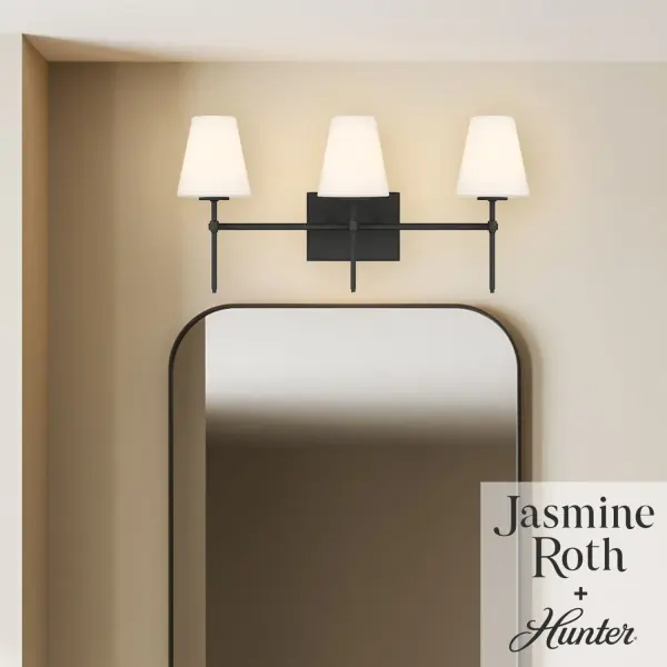 Create a warm, welcoming glow with the Camelia Stem Jasmine Roth 3 Light Vanity. Designed for bathrooms and other humidity-prone spaces, this indoor-damp rated fixture blends effortless style with a comfortable, laid-back feel. Its versatile design mounts up or down to suit your space, while three E12 bulbs, sold separately, provide customizable illumination. Thoughtfully crafted to coordinate with the Jasmine Roth lighting collection, this vanity light brings casual elegance and dependable performance, backed by Hunter's one-year limited warranty. Rated for indoor spaces exposed to humidity. Mounts Up only Comfortable, inviting, laid-back. Requires 3 E12 bulbs required (not included). INDOOR-DAMP RATED: For use in indoor spaces exposed to humidity like bathrooms and laundry rooms. CASUAL: The effortless style of Casual design creates a comfortable, inviting, and laid-back atmosphere. ANGLED CEILINGS: This fixture can be mounted on both angled and flat ceilings. COORDINATING COLLECTION: Works with Jasmine Roth Lighting collection. WARRANTY: One-year limited warranty backed by the trusted experts at Hunter. - alternate view