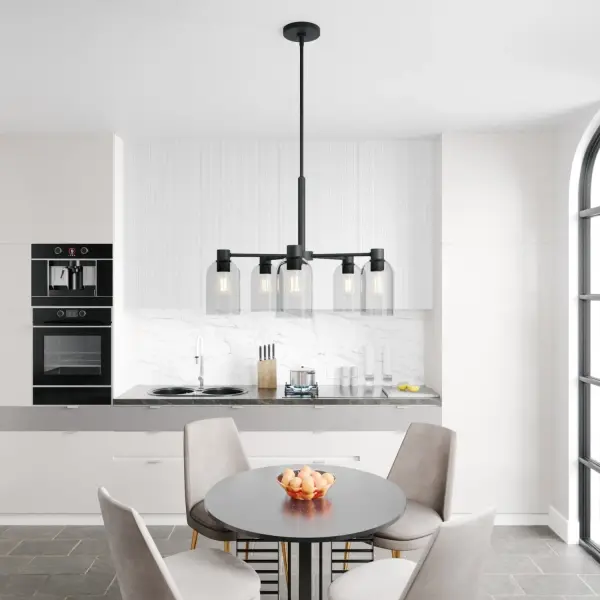 The Lochemeade chandelier combines minimalist design with industrial appeal through its natural black iron finish and smoked glass dome shades. Its versatile 26-inch width makes it suitable for medium-sized spaces. - alternate view