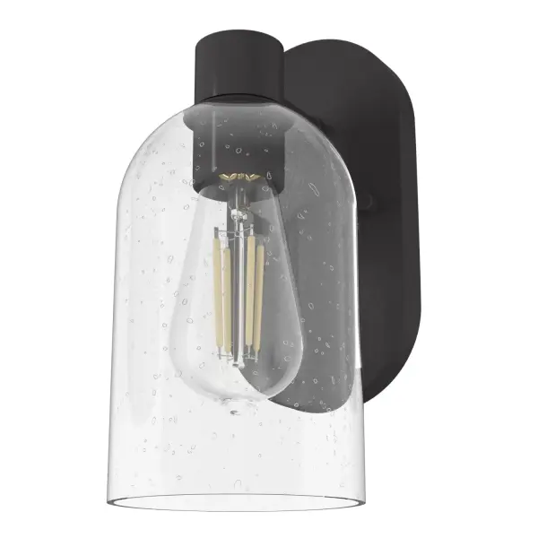 The Lochemeade wall sconce embodies sophisticated minimalism with its striking seeded glass dome and noble bronze finish. Compact yet impactful, it delivers ambient lighting perfect for intimate spaces while maintaining a clean, modern aesthetic.