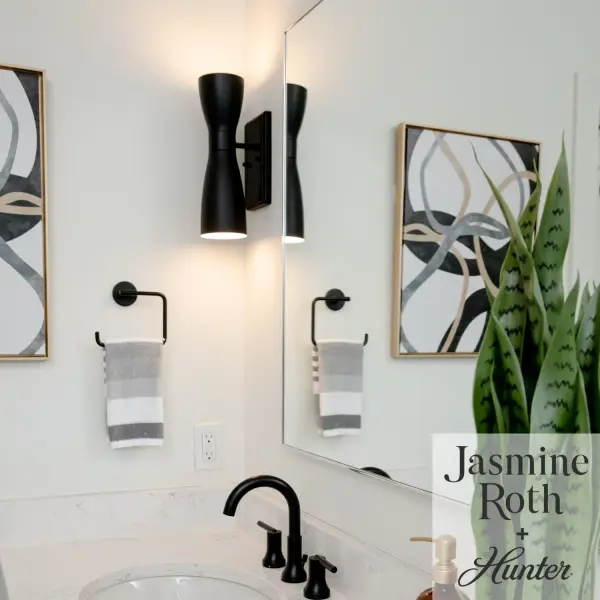 Designed in collaboration with Jasmine Roth, this eye-catching wall sconce features distinctive pharmacy shades that direct light both up and down. The sculptural silhouette and matte black finish make it a commanding focal point. - alternate view