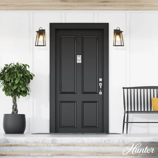 The Ivory Dusk wall light combines traditional cottage charm with weather-resistant aluminum construction. Its tapered silhouette and sculpted details create timeless curb appeal while the matte black finish adds contemporary edge. - alternate view