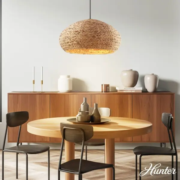 The Cambria pendant brings natural warmth through handwoven seagrass paired with sleek matte black hardware. Its 24-inch dome creates substantial presence while the organic material softens the light beautifully. A versatile transitional piece that bridges contemporary and coastal aesthetics. - alternate view
