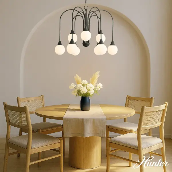The Valadon delivers refined elegance with exaggerated curved arms and twist-lock globe glass. Its matte black finish and cased white glass create warm, diffused light perfect for modern-transitional spaces seeking both comfort and edge. - alternate view