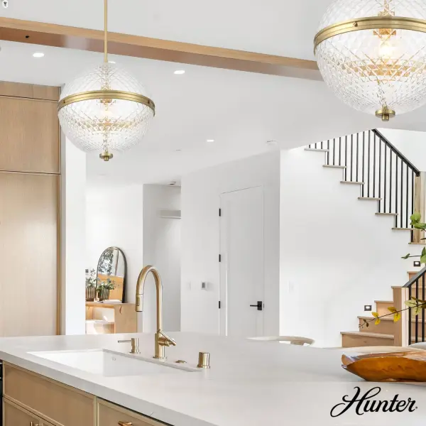 The Bay Hollow pendant combines transitional elegance with contemporary flair through its diamond-textured glass globe that creates captivating light patterns. The warm Alturas Gold finish adds sophistication while maintaining versatility across design styles. - alternate view